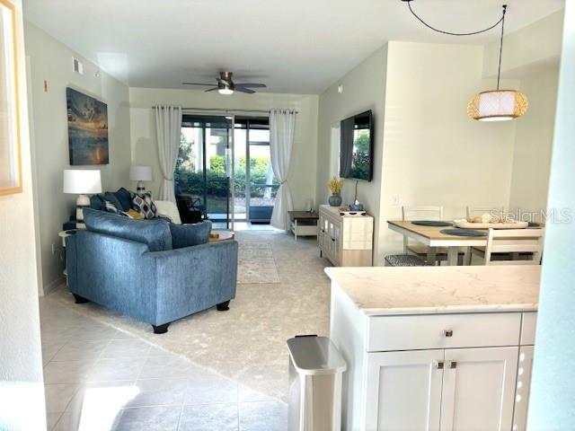 8369 Wingate Drive, Unit 2114 Sarasota, FL 34238 - Photo 10 of 26 a living room with furniture and a large window