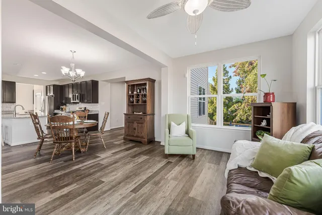 a room with stainless steel appliances lots of wooden furniture a dining table and chairs in it