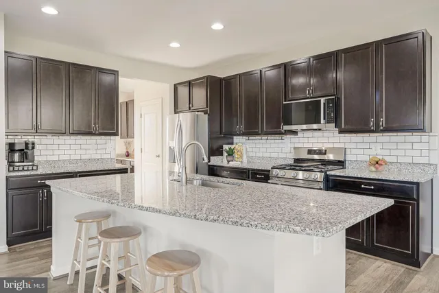 a front view of a house with a yard table and chairs