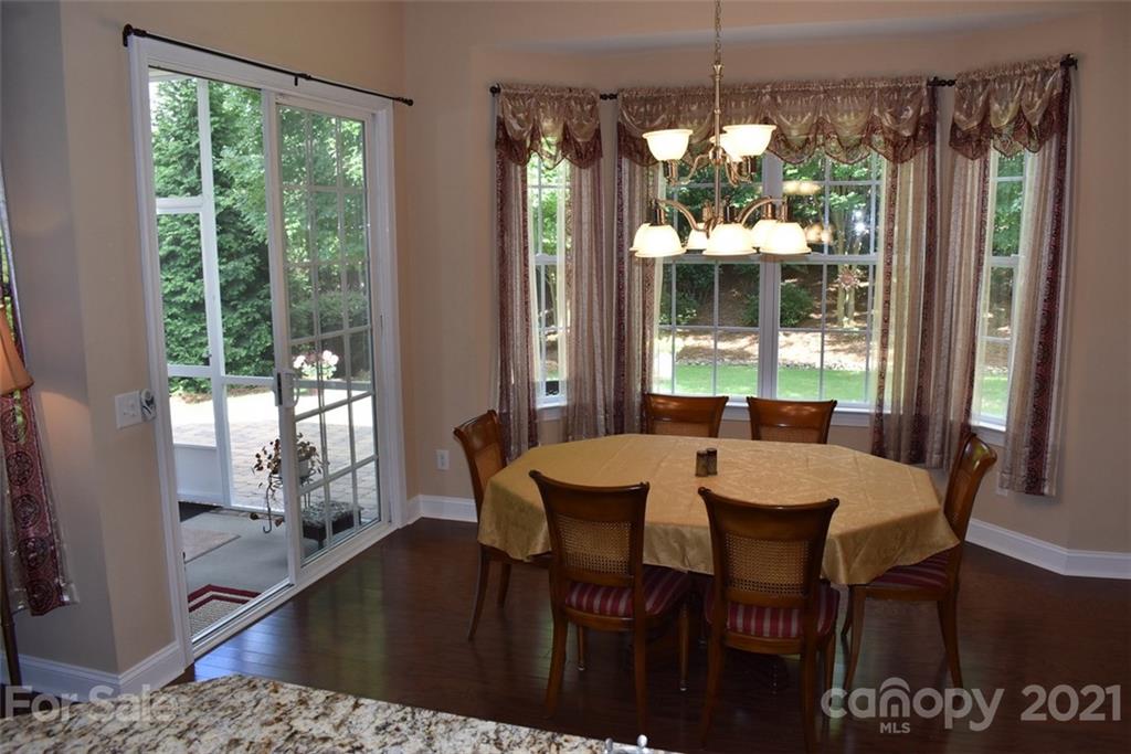 1321 Secret Path Drive Fort Mill, SC 29708 - Photo 14 of 40 a view of a dining room with furniture wooden floor and a chandelier