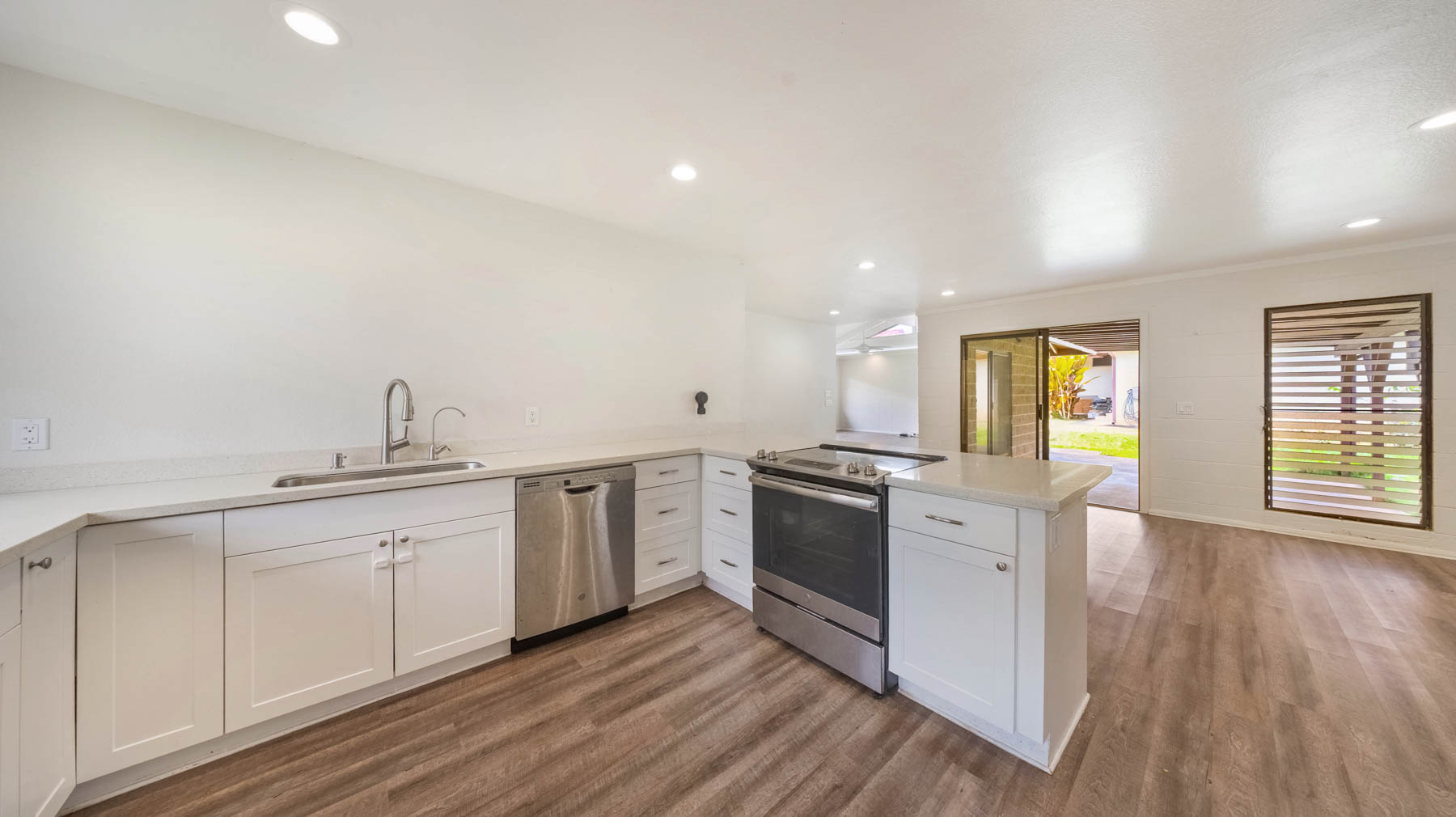 328 Molo Street Kapaa, HI 96746 - Photo 16 of 30 a kitchen with granite countertop a sink cabinets and wooden floor