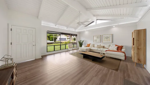 a living room with furniture and a floor to ceiling window