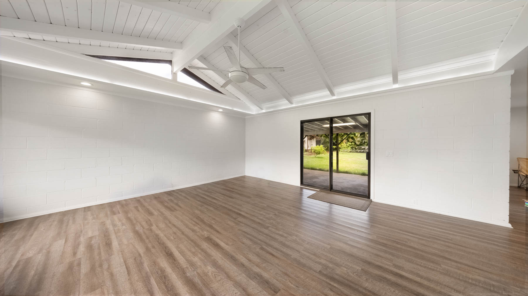 328 Molo Street Kapaa, HI 96746 - Photo 6 of 30 a view of an empty room with wooden floor and a window