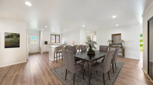 a view of a dining room with furniture and wooden floor