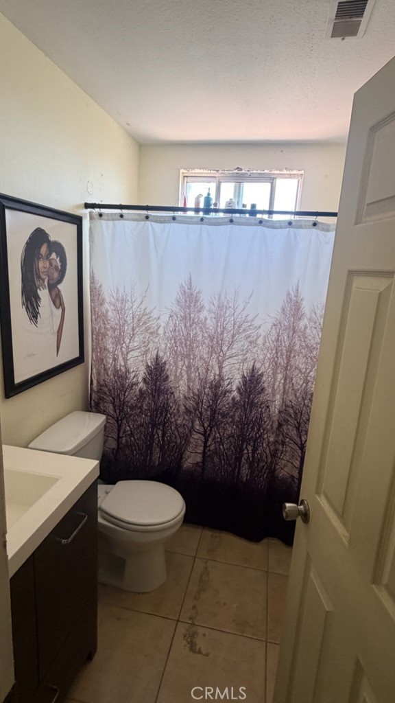 2478 KOA Drive Rialto, CA 92377 - Photo 3 of 18 a bathroom with a toilet and a shower