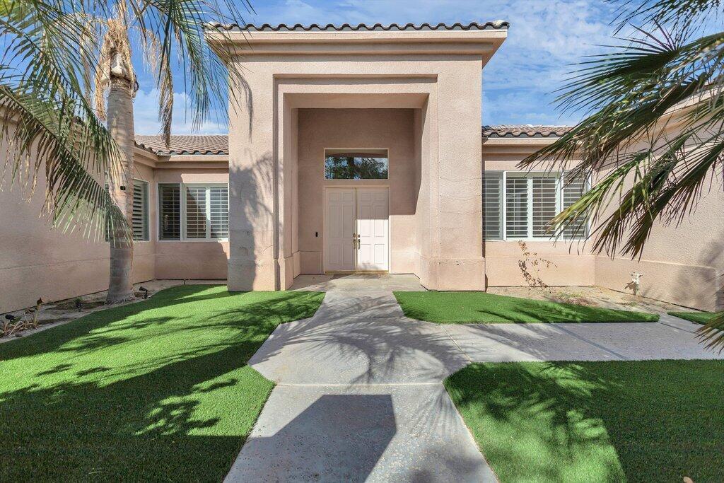 8 MacBeth Court Rancho Mirage, CA 92270 - Photo 3 of 46 a front view of a house with a yard
