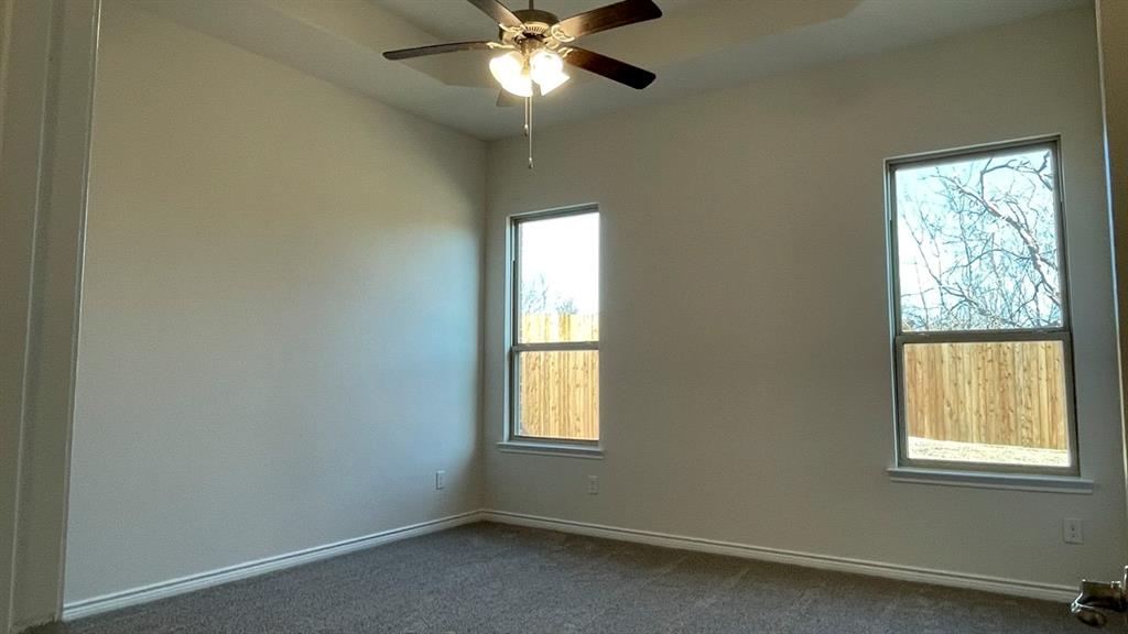 4189 Rim Trail Forney, TX 75126 - Photo 6 of 17 an empty room with a window and a fan