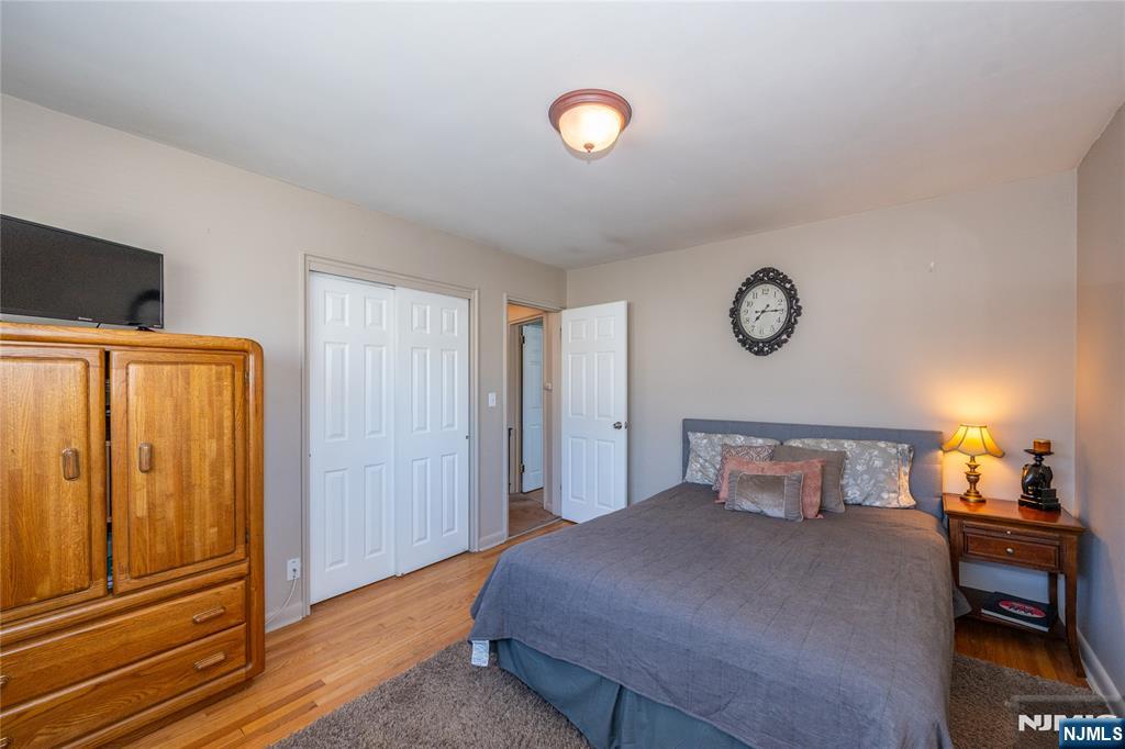 54 Harrison Street Dumont, NJ 07628 - Photo 18 of 35 a bedroom with a bed and cabinets