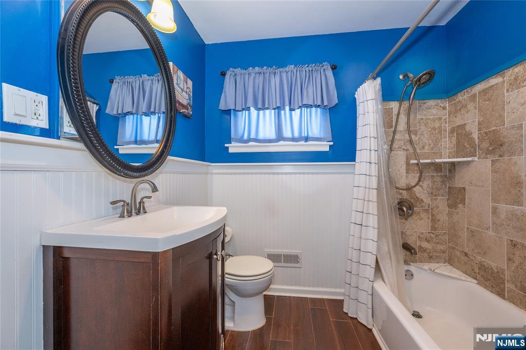 54 Harrison Street Dumont, NJ 07628 - Photo 21 of 35 a bathroom with a sink and a mirror