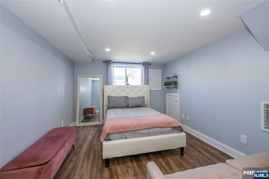 54 Harrison Street Dumont, NJ 07628 - Photo 22 of 35 a bedroom with a bed and wooden floor