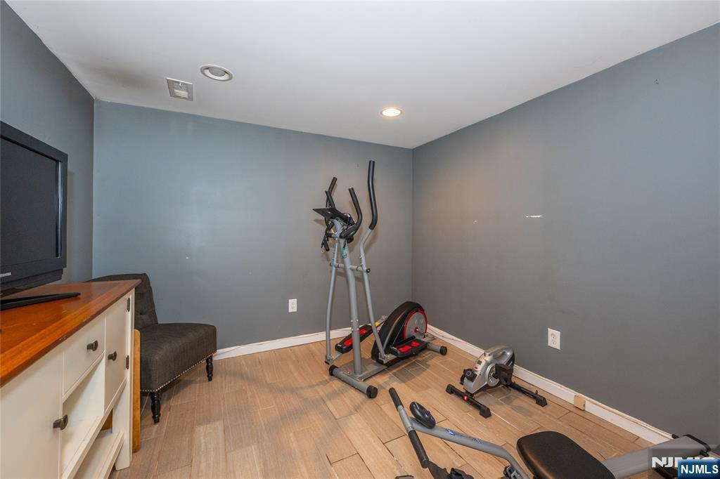54 Harrison Street Dumont, NJ 07628 - Photo 23 of 35 a bedroom with a bed and a flat screen tv
