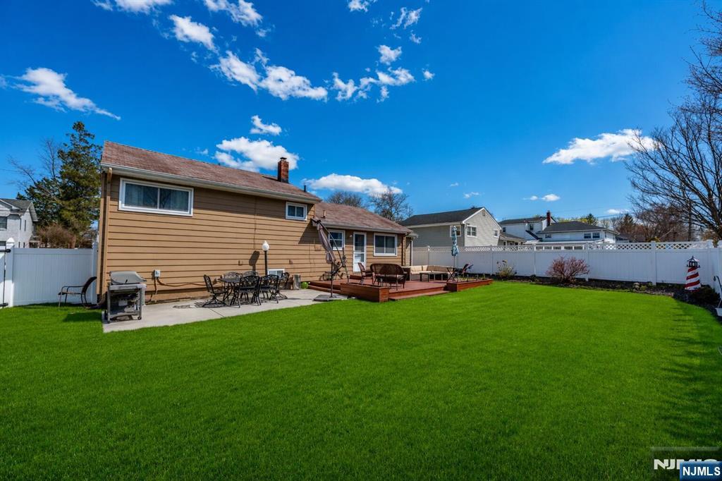 54 Harrison Street Dumont, NJ 07628 - Photo 29 of 35 a front view of a house with patio and garden