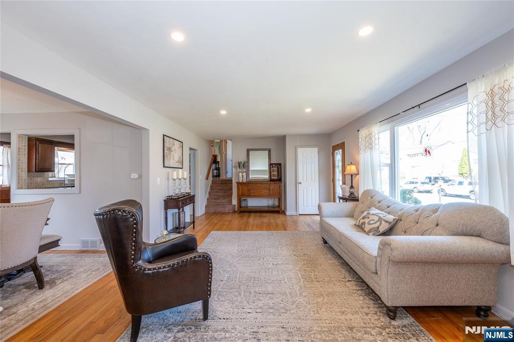 54 Harrison Street Dumont, NJ 07628 - Photo 4 of 35 a living room with furniture and large windows