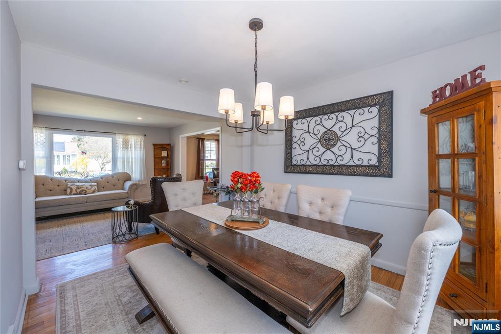 54 Harrison Street Dumont, NJ 07628 - Photo 8 of 35 a living room with furniture a chandelier and a table
