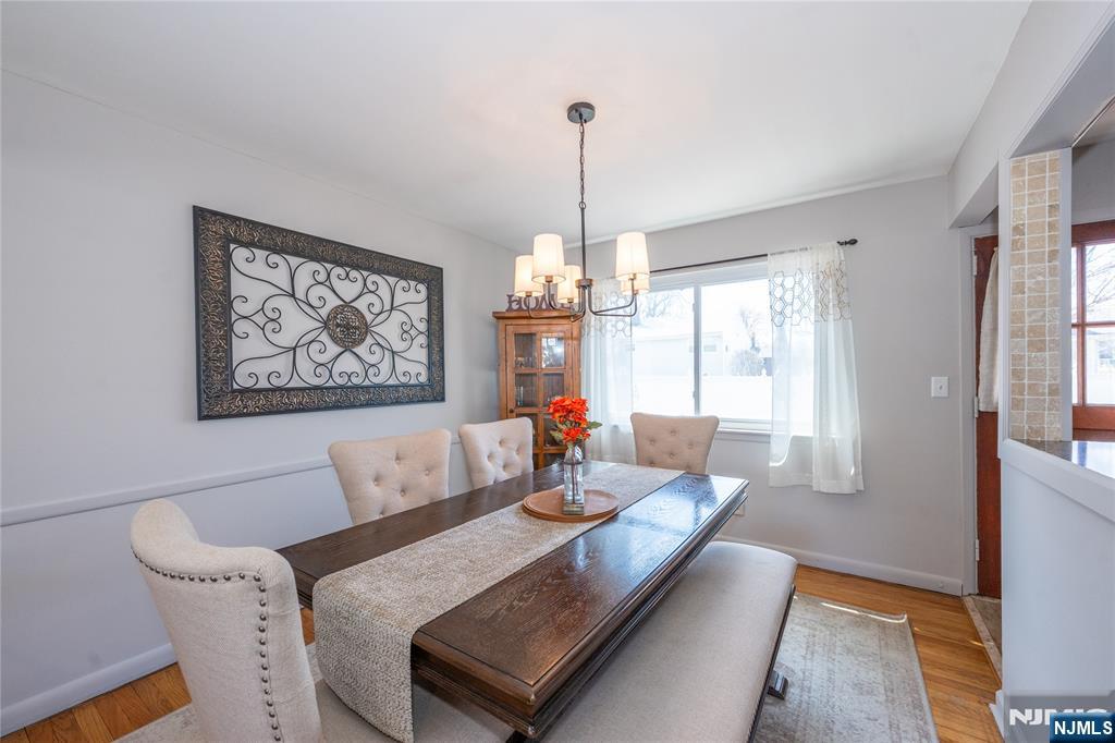 54 Harrison Street Dumont, NJ 07628 - Photo 9 of 35 a living room with furniture and a chandelier