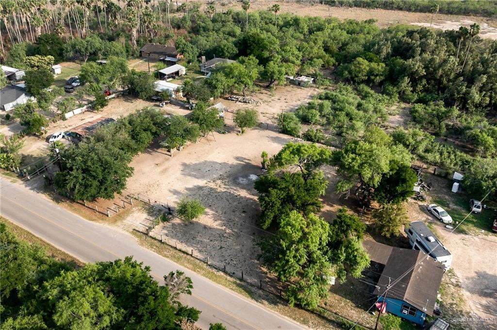 7585 Chihuahua Road Mission, TX 78572 - Photo 7 of 8 an aerial view of residential house with outdoor space and trees all around