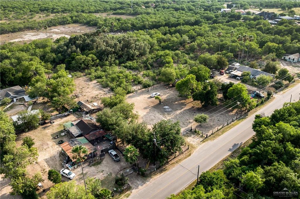 7585 Chihuahua Road Mission, TX 78572 - Photo 8 of 8 an aerial view of residential house with outdoor space and trees all around
