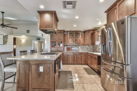 1220 Jennifer Court Ridgecrest, CA 93555 - Photo 8 of 34 a kitchen with stainless steel appliances granite countertop a sink a stove and a refrigerator