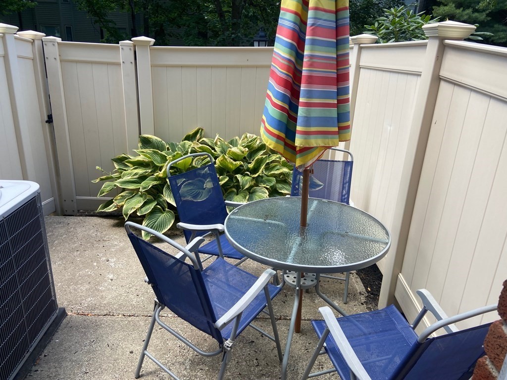 44 Regent Circle, Unit 44 Brookline, MA 02445 - Photo 2 of 10 a dining room with furniture and wooden floor