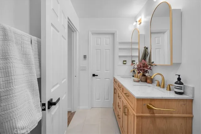 a bathroom with a double vanity sink a mirror and shower