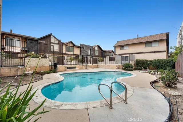 a view of a house with swimming pool and sitting area