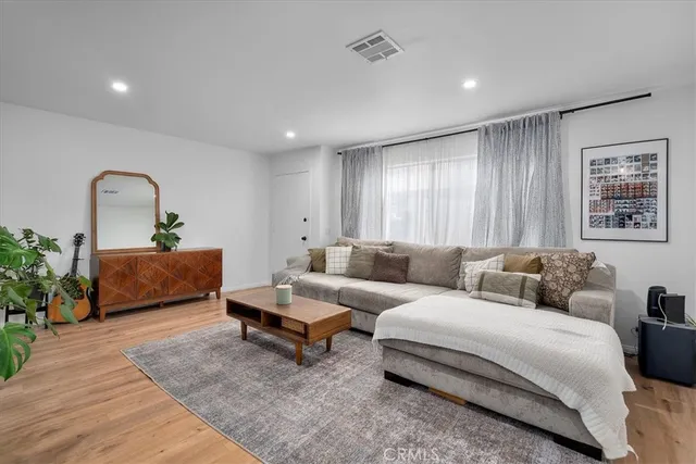 a living room with furniture and a mirror