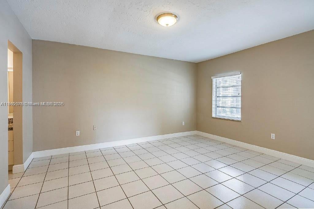 8305 Southwest 72nd Avenue, Unit 102A Miami, FL 33143 - Photo 2 of 18 a view of an empty room and window