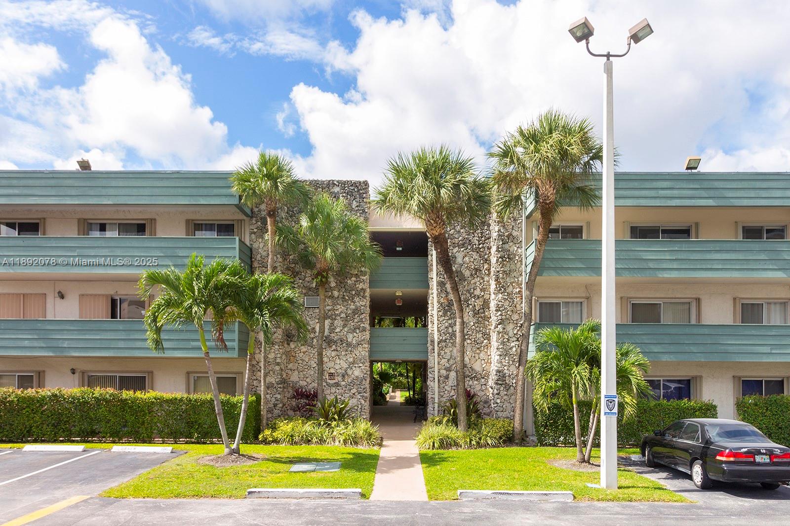 8305 Southwest 72nd Avenue, Unit 102A Miami, FL 33143 - Photo 5 of 18 a front view of a building with garden