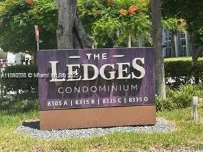 a sign that is sitting on a wooden wall