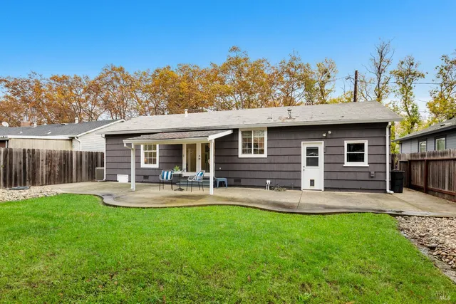 a front view of house with a garden and patio