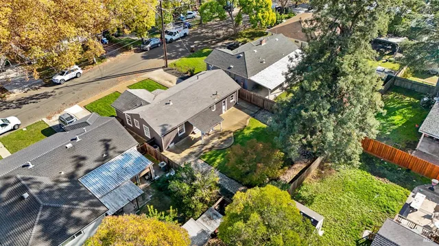 an aerial view of a house with a garden and swimming pool