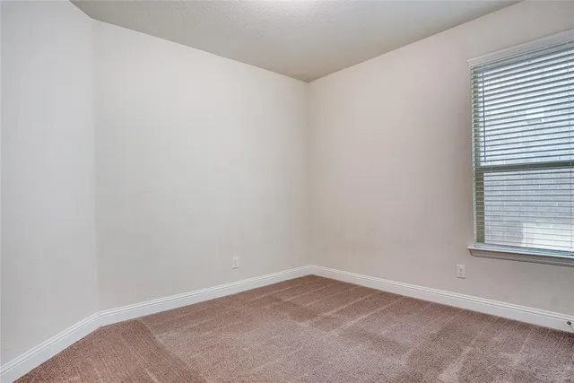a view of a backyard with table and chairs a barbeque and wooden fence