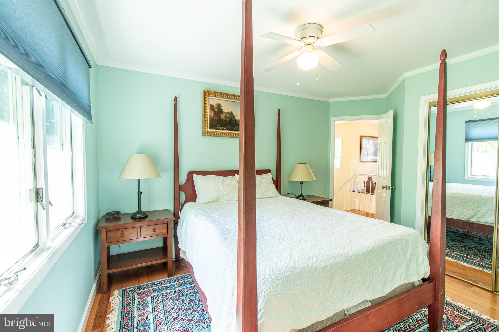 102 Jacks Point Road Oxford, MD 21654 - Photo 36 of 83 a bedroom with a bed and a chandelier