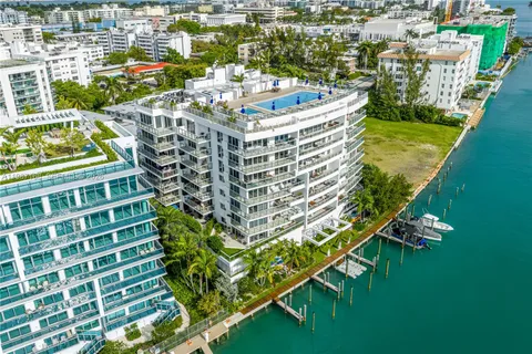 an aerial view of a house with lake view and a floor to ceiling window
