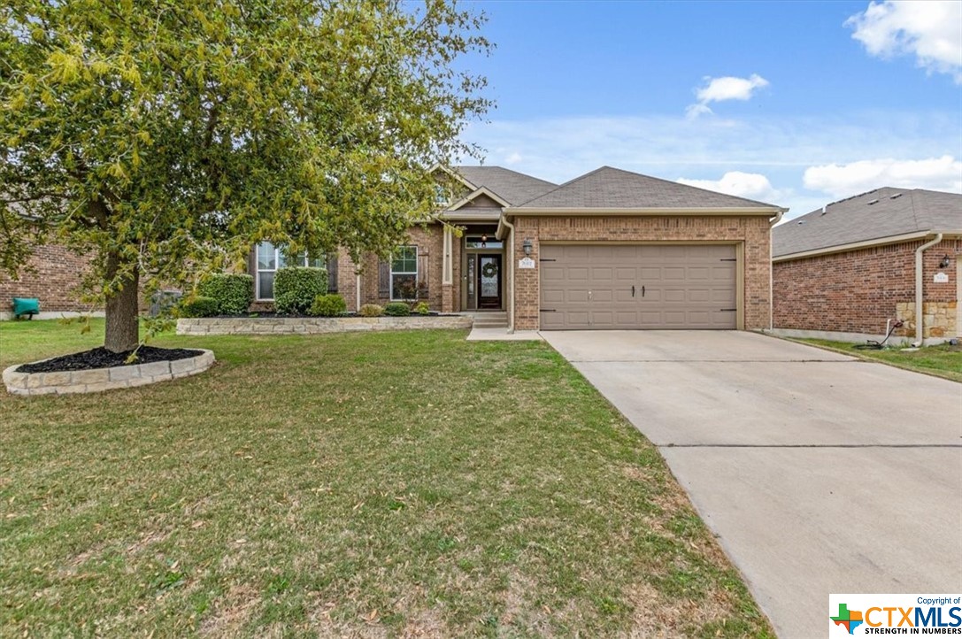 a front view of a house with a yard and garage