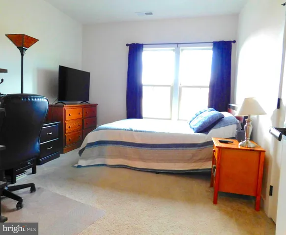 a bedroom with bed and window