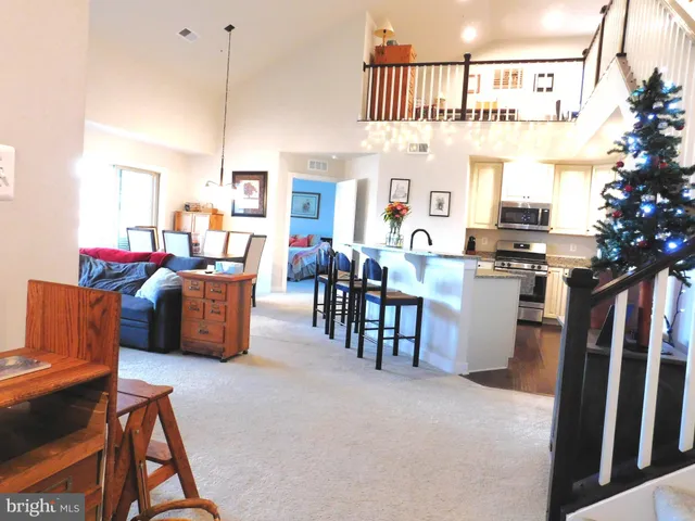 a living room with furniture a fireplace and a chandelier