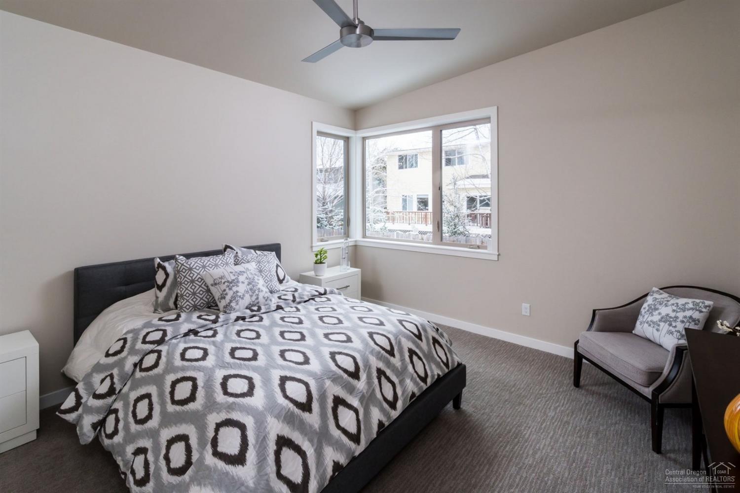 63193 Iner Loop Bend, OR 97701 - Photo 5 of 15 a bedroom with a bed and a chair