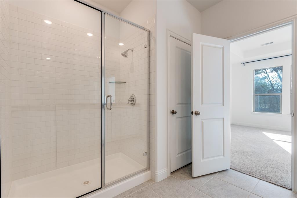 1400 Elizabeth Street Anna, TX 75409 - Photo 15 of 25 a bathroom with a shower and a glass door