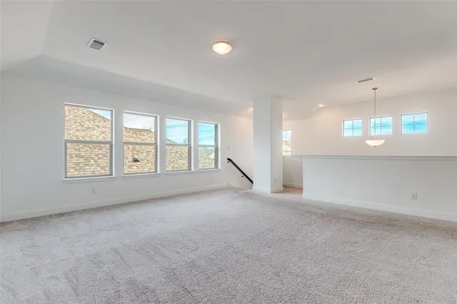 an empty room with a empty space and windows