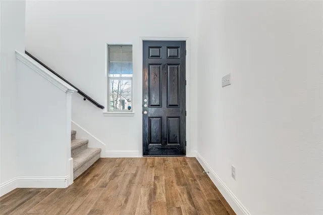 a view of an entryway with wooden floor