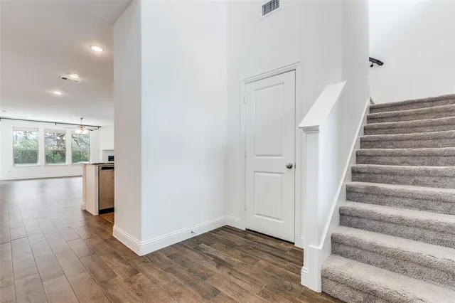 a view of an entryway with wooden floor and door