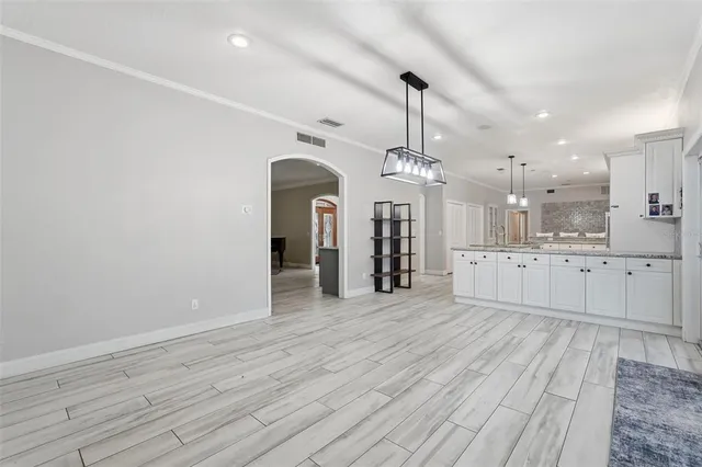 a living room with furniture a fireplace and wooden floor