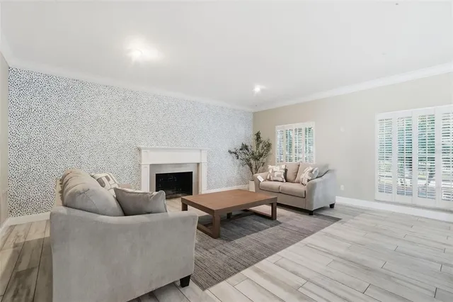 a view of a livingroom with wooden floor and furniture