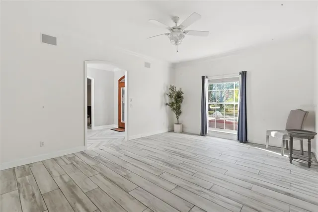 a living room with furniture and a floor to ceiling window