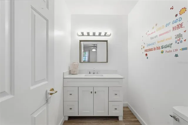 a bathroom with a tub a sink and a mirror