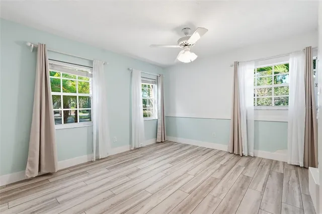 wooden floor in an empty room with a mirror