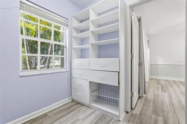 a bathroom with a granite countertop sink toilet and mirror