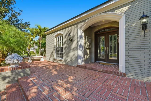 a view of a brick house with many windows