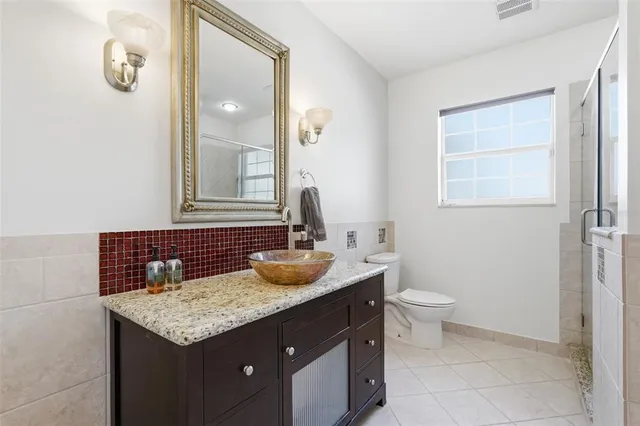 a bathroom with a shower sink and mirror